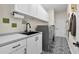 Well-equipped laundry room with modern appliances, patterned floors, and ample counter space at 13137 Lake Butler Blvd, Windermere, FL 34786