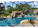 Beautiful screened pool with rock waterfall and connected hot tub, as well as outdoor seating areas at 13137 Lake Butler Blvd, Windermere, FL 34786