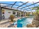 Beautiful screened pool featuring brick pavers and natural rock accents provides the perfect outdoor retreat at 13137 Lake Butler Blvd, Windermere, FL 34786