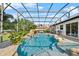 Beautiful backyard swimming pool with waterfall feature, screened enclosure, and adjacent seating area at 13137 Lake Butler Blvd, Windermere, FL 34786