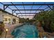 Lovely screened pool area features tropical landscaping, rock waterfall and screened enclosure for year-round enjoyment at 13137 Lake Butler Blvd, Windermere, FL 34786