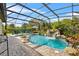 Beautiful screened pool and hot tub surrounded by lush landscaping and an outdoor seating area at 13137 Lake Butler Blvd, Windermere, FL 34786