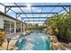 Inviting screened pool area with rock waterfall and outdoor seating area at 13137 Lake Butler Blvd, Windermere, FL 34786