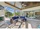 Inviting sunroom features an outdoor living area, wood ceilings, and views of lush greenery at 13137 Lake Butler Blvd, Windermere, FL 34786