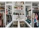 Organized walk-in closet with glass display for accessories and custom shelving for clothing at 13137 Lake Butler Blvd, Windermere, FL 34786