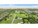 Beautiful aerial view of a well-manicured property with lush greenery, several outbuildings, and mature trees at 150 Berkley Knights Dr, Auburndale, FL 33823