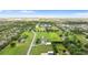 Scenic aerial view of property, featuring a long driveway, a beautiful single Gathering home, and lush greenery at 150 Berkley Knights Dr, Auburndale, FL 33823
