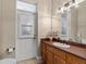 Bright bathroom with a sink and door to the exterior at 150 Berkley Knights Dr, Auburndale, FL 33823