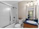This bathroom features a shower/bathtub combination and blue bathroom vanity at 150 Berkley Knights Dr, Auburndale, FL 33823