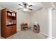 Bright bedroom featuring a wooden bookcase and neutral walls at 150 Berkley Knights Dr, Auburndale, FL 33823