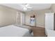 Cozy bedroom featuring a ceiling fan and an open door with view of the upstairs hallway at 150 Berkley Knights Dr, Auburndale, FL 33823