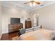 Inviting bedroom with hardwood floors, tray ceilings, and a furniture chest at 150 Berkley Knights Dr, Auburndale, FL 33823