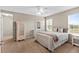 Comfortable bedroom featuring a ceiling fan, a large window, and neutral decor at 150 Berkley Knights Dr, Auburndale, FL 33823