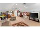 Spacious bonus room featuring sports memorabilia, a comfortable recliner, and a large flat-screen television at 150 Berkley Knights Dr, Auburndale, FL 33823
