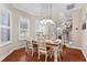 Dining room with modern pendant lighting and views of the staircase to the second story at 150 Berkley Knights Dr, Auburndale, FL 33823