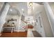 Grand foyer featuring a staircase, decorative lighting, and arched doorways to other rooms at 150 Berkley Knights Dr, Auburndale, FL 33823