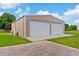 Spacious garage with two roll-up doors, offering ample parking and storage space at 150 Berkley Knights Dr, Auburndale, FL 33823