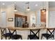 Kitchen with a granite breakfast bar, stainless steel appliances, and wood cabinetry at 150 Berkley Knights Dr, Auburndale, FL 33823