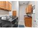 Functional laundry room with modern washer and dryer, plus convenient cabinet storage at 150 Berkley Knights Dr, Auburndale, FL 33823