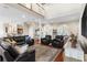 Open concept living room with a second-story overlook, hardwood floors, and a leather seating arrangement at 150 Berkley Knights Dr, Auburndale, FL 33823