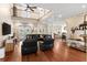 Spacious living room with high ceilings, hardwood floors, and access to outdoor spaces at 150 Berkley Knights Dr, Auburndale, FL 33823