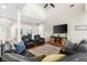 Comfortable living room with vaulted ceiling, plush seating, and ample natural light at 150 Berkley Knights Dr, Auburndale, FL 33823