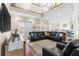 Spacious living room with vaulted ceilings, leather seating, and views of the outdoor pool at 150 Berkley Knights Dr, Auburndale, FL 33823
