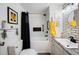 Bathroom featuring black and white tile work, storage, and modern fixtures at 1506 Longbow Dr, Lakeland, FL 33810