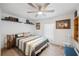 Bright bedroom with comfortable bedding, open shelving, and a neutral color scheme, creating a cozy and inviting space at 1506 Longbow Dr, Lakeland, FL 33810