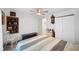 Charming bedroom featuring a striped comforter, built-in shelving, and ample natural light, creating a welcoming and cozy retreat at 1506 Longbow Dr, Lakeland, FL 33810