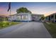 Charming single-story home featuring a covered carport, well-maintained lawn, and tasteful landscaping at 1506 Longbow Dr, Lakeland, FL 33810
