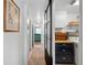 Hallway with a view of the bedroom and laundry room, showcasing the home's layout and convenient amenities at 1506 Longbow Dr, Lakeland, FL 33810