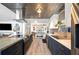 Modern kitchen featuring stainless steel appliances, stylish cabinets, and unique ceiling design at 1506 Longbow Dr, Lakeland, FL 33810