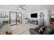 Comfortable living room with modern decor, a large TV, and access to the sunroom at 1506 Longbow Dr, Lakeland, FL 33810