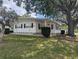Charming single-story home with white siding, black shutters, and a well-maintained lawn at 1610 Reynolds Rd # 80, Lakeland, FL 33801