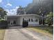 Cozy home with a carport and well-manicured lawn on a sunny day at 1610 Reynolds Rd # 80, Lakeland, FL 33801