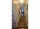 Hallway leading to the Primary bedroom with wood-look flooring at 1610 Reynolds Rd # 80, Lakeland, FL 33801