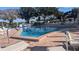 Community pool featuring inviting, clear blue water and plenty of lounge chairs at 1610 Reynolds Rd # 80, Lakeland, FL 33801