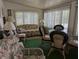 Relaxing sun room with large windows, vertical blinds, and comfortable seating at 1610 Reynolds Rd # 80, Lakeland, FL 33801