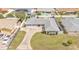 An aerial view of a single-story home with a grey roof and an expansive driveway at 170 Browning Cir, Winter Haven, FL 33884