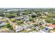This aerial view highlights a property with mature trees, solar panels, and a fenced backyard with a swimming pool at 170 Browning Cir, Winter Haven, FL 33884