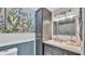 Updated bathroom featuring a floral wallpaper, modern lighting, and a sleek gray vanity at 170 Browning Cir, Winter Haven, FL 33884