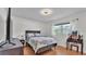 Cozy bedroom with hardwood floors, a window, and stylish furniture at 170 Browning Cir, Winter Haven, FL 33884