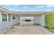 Covered carport with access doors on either side and a view of the backyard at 170 Browning Cir, Winter Haven, FL 33884