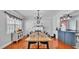Open-concept dining room with a fireplace, hardwood floors and plenty of seating at 170 Browning Cir, Winter Haven, FL 33884