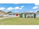 Charming single-story home featuring a red front door and well-manicured landscaping at 170 Browning Cir, Winter Haven, FL 33884