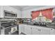 Bright kitchen featuring white cabinets, stainless steel appliances, and backsplash at 170 Browning Cir, Winter Haven, FL 33884