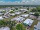 Aerial view of a charming single-story home surrounded by community amenities and near a serene lake at 1823 Sherwood Hill Dr, Lakeland, FL 33810