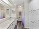 Bathroom view with walk-in shower, single sink vanity and built-in storage at 1823 Sherwood Hill Dr, Lakeland, FL 33810