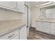 Bathroom with white cabinets, laminate countertop, and closet at 1823 Sherwood Hill Dr, Lakeland, FL 33810